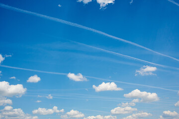 Contrails in the blue sky, often used for conspiracy theories