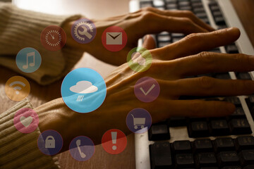 Female hands on laptop keyboard and image overlay of weather icon