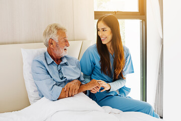 Old man with caregivers at home. Elderly health care concept.