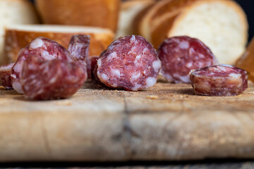 sausage sliced with a baguette on a wooden board