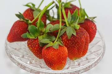 Strawberry in a plate on a white background