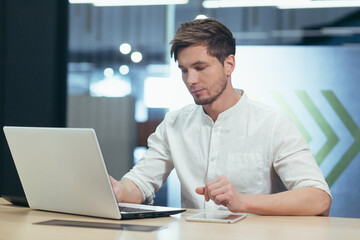 Young man thinking in office, businessman working with laptop on business plan and startup development strategy