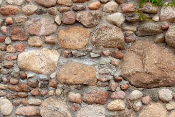part of an old wall made of clay bricks and polished hewn stones