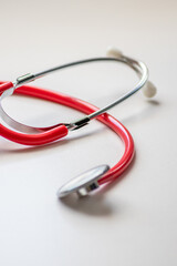 Red stethoscope in doctors office for professional cardio checkup and healthy heartbeat pulse check...