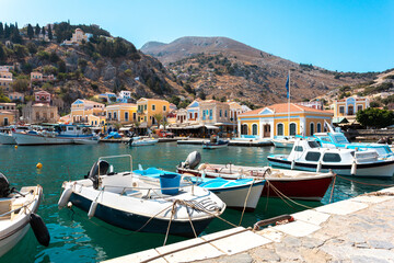 Fototapeta na wymiar View on Greek sea Symi island harbor port, houses on island hills.