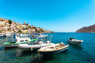 Fototapeta na wymiar View on Greek sea Symi island harbor port, houses on island hills.