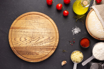 Pizza cutting board and ingredients on table. Bread recipe cooking at tabletop background