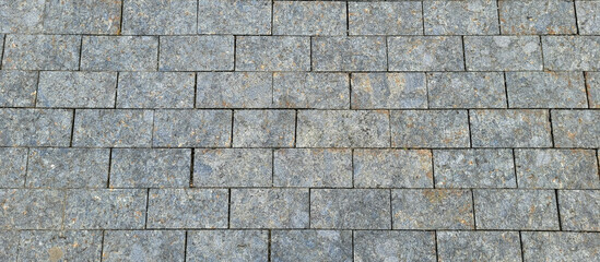 Texture of concrete pavement or sidewalk with paving slabs, top view. Blocks of the sidewalk...