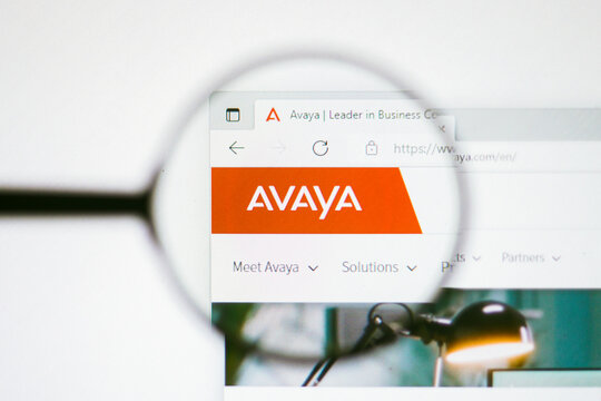 June 13, 2022, Brazil. In this photo illustration, the homepage of the Avaya Inc. website seen on a computer screen through a magnifying glass.