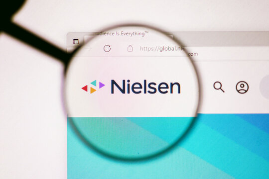 June 13, 2022, Brazil. In this photo illustration, the homepage of the Nielsen Holdings website seen on a computer screen through a magnifying glass.