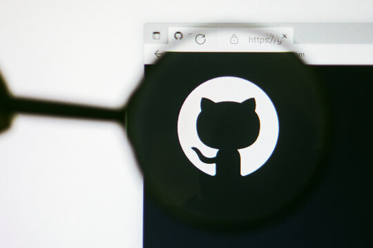 June 13, 2022, Brazil. In this photo illustration, the homepage of the GitHub website seen on a computer screen through a magnifying glass.