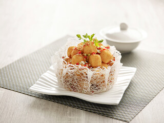 Crispy-fried Tofu with Salt and Pepper served in a dish isolated on mat side view on grey background