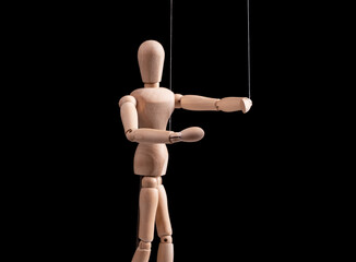 Puppet on strings. Manipulation, control, power, abuse concept. Marionette in human hand. High...