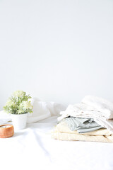 Linen fabrics with flowers and candle on white background