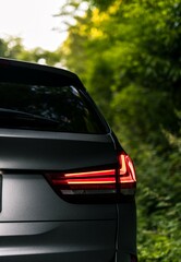 Tail light on a gun metal grey suv