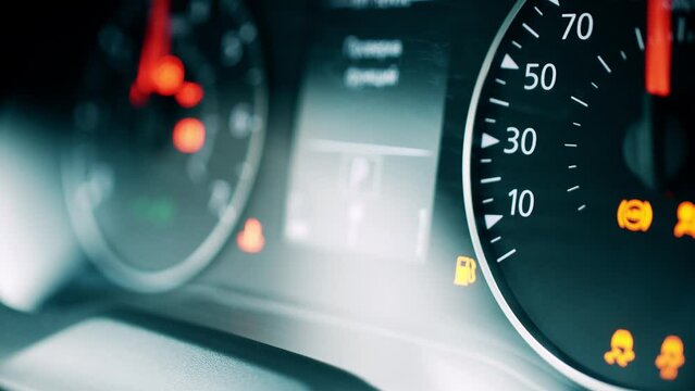 Car low fuel level indicator light, close-up shot