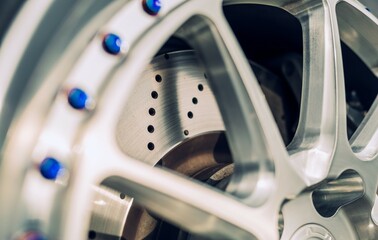 Car wheel with drilled brake rotor behind the wheel