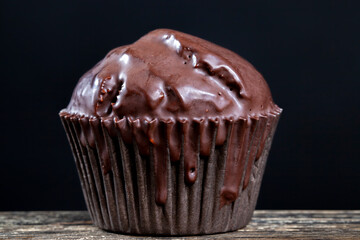 chocolate cupcake in black paper packaging