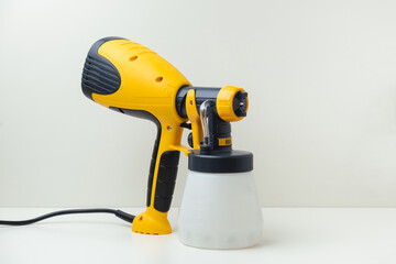 Professional yellow spray gun isolated on white background