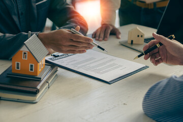 Home agents talk to new home buyers and offer good interest rates and calculate clients on mortgage financing to help make real estate concept decisions.