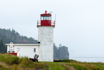 Cape Dor Lighthouse on a rainy, foggy day, Nova Scotia, Canada.