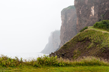 Coastal scene of Cape D'or cliffs on a rainy, foggy day, Nova Scotia, Canada.