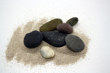 Obraz na płótnie Canvas Sea round stones on the fine sand. Selective focus.