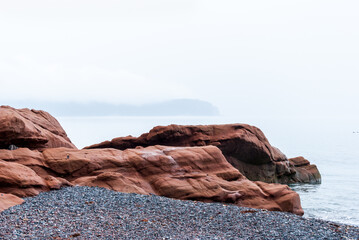 Red rocks of Cape Chignecto, foggy morning
