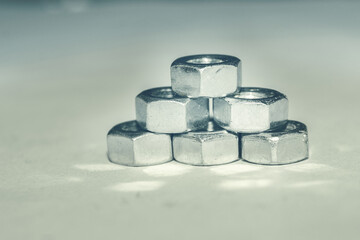 Pyramid of metal nuts. Nuts for bolts. Metals and solid parts
