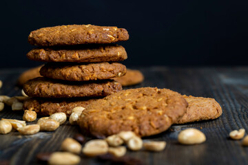 oatmeal cookies with peanuts on a black wooden table