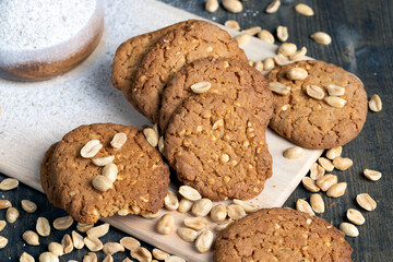 oatmeal cookies with peanuts on a black wooden table