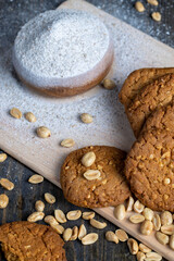 oatmeal cookies with peanuts on a black wooden table
