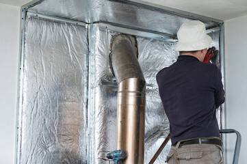 Installation of mineral wool with foil around the fireplace for thermal protection and high...