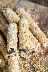 waffle tube with chocolate filling and crushed peanuts