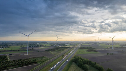 Panoramic aerial drone view of wind farm or wind park, with high wind turbines for generation...
