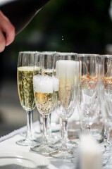Waiter pouring champagne into glass