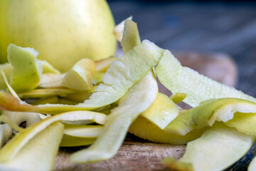 sliced and peeled green apple on a wooden board