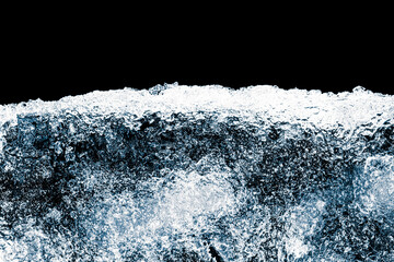 Piece of the ice. Textured, blue tone, ice block's cold, frosty surface on black background.