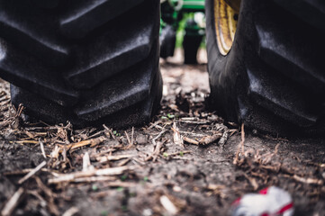 Soil compaction caused by a dual tractor tires over topsoil dirt in an empty field before planting.