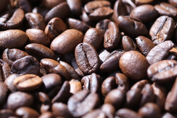 Coffee roasted beans closeup, coffee macro close up, selective focus. Defocused natural blurred background.