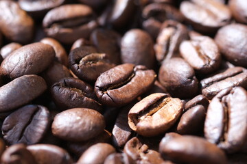 Coffee roasted beans closeup, coffee macro close up, selective focus. Defocused natural blurred background