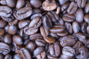 Coffee roasted beans closeup, coffee macro close up, selective focus. Defocused natural blurred background