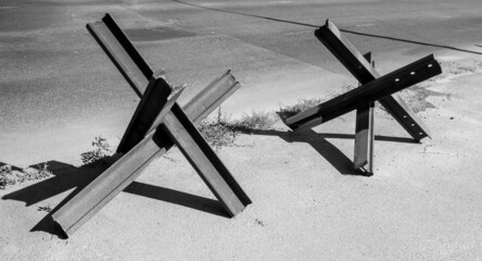 Two protective anti-tank hedgehogs on the street of Odessa, Ukraine. White and black background picture.