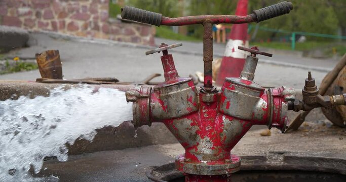 Slow Motion Draining water from building plumbing system. Water flows from faucet and pipe