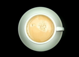 Cup of coffee and milk on black background