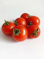 small bright cherry tomatoes on a white background