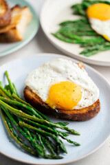 Fried eggs with toasted bread and green asparagus. Fast lunch ideas, healthy breakfast, summer food.