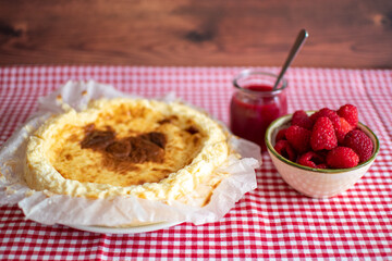 Traditional cheesecake with fresh raspberries.