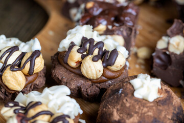 multicomponent cake made of caramel and nuts in chocolate