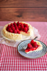 Delicious slice of cheesecake decorating with raspberries